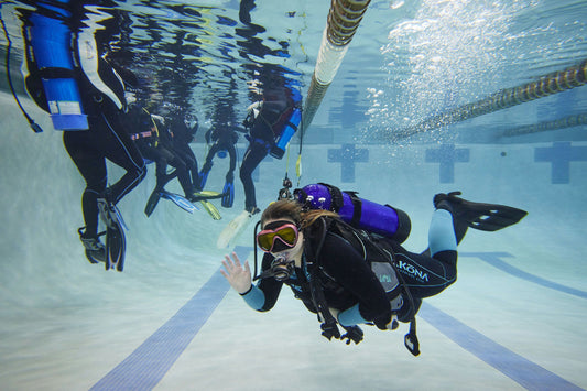 person in class diving underwater